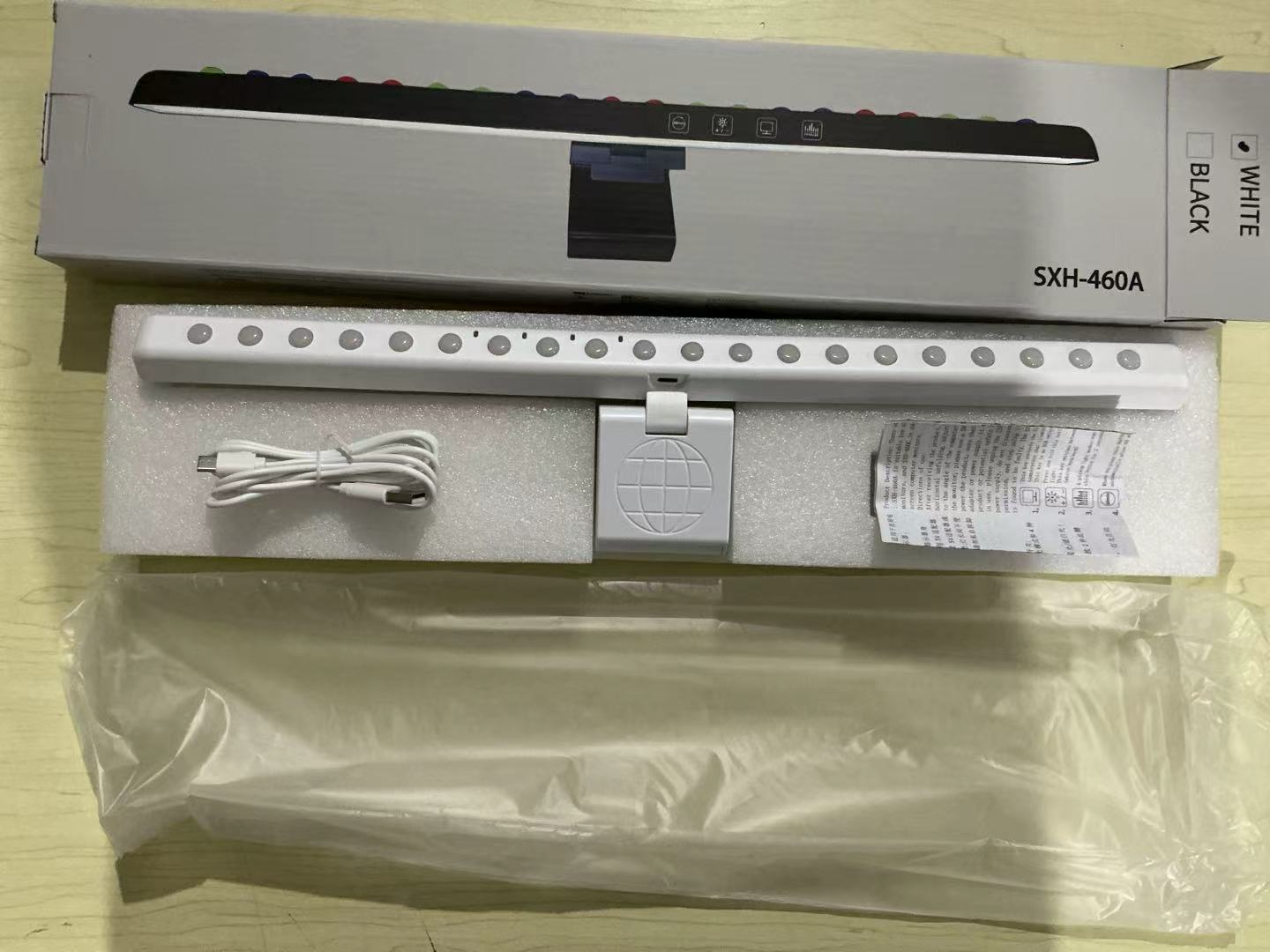 A hanging light on the computer monitor